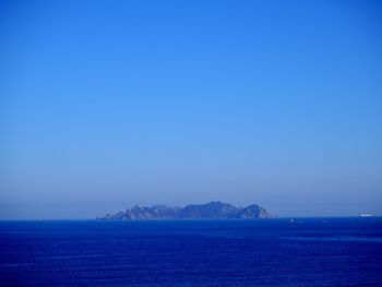 Scenic view of sea against clear blue sky