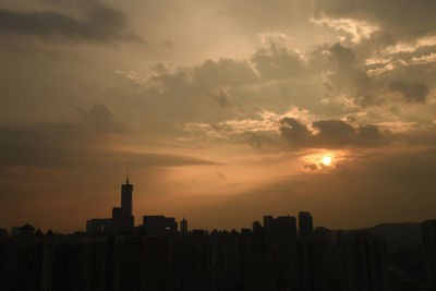 Silhouette buildings against sky during sunset