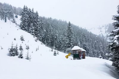 Ski lift against sky during winter