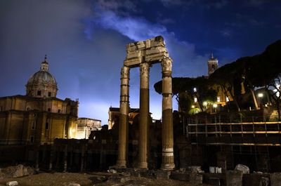 Roman forum at night while thundestorm looms on the horizon.