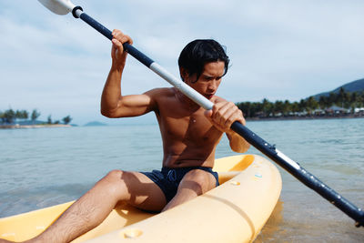 Portrait of man kayaking in sea