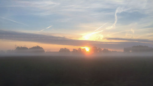 Scenic shot of landscape against sky at sunset