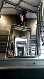 High angle view of people walking on spiral steps