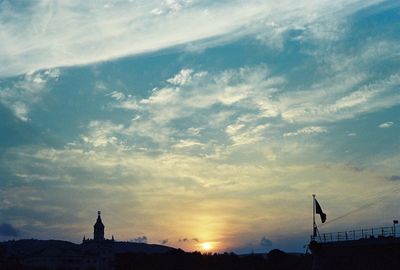 Silhouette built structure against sky during sunset