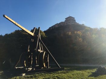 Traditional windmill on field against clear sky