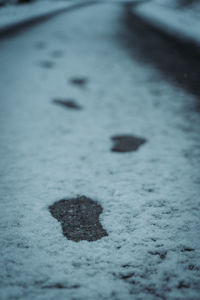 High angle view of footprints on snow covered street