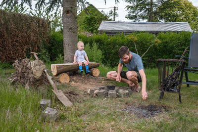 Side view of man sitting on field