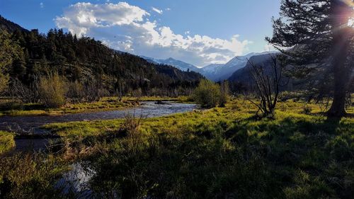 Scenic view of lake and mountains against sky