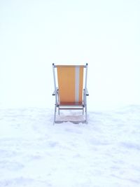 Lifeguard hut on snow against clear sky