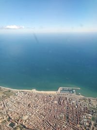 High angle view of sea and buildings against sky