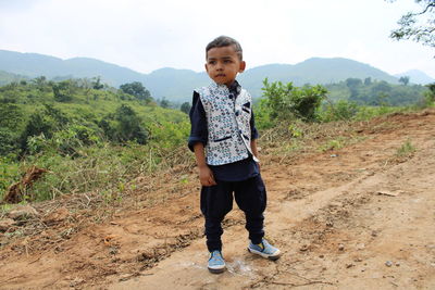 Full length of boy standing on field