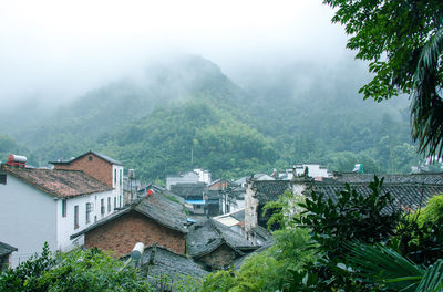 High angle view of houses and buildings against sky