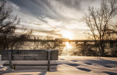 Scenic view of snow covered landscape against sky during sunset