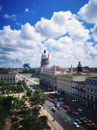 View of cityscape against cloudy sky