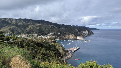 High angle view of sea and mountains against sky