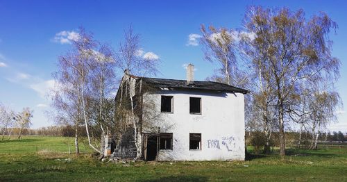 Abandoned house on field against sky