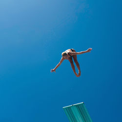 Low angle view of woman swimming in pool