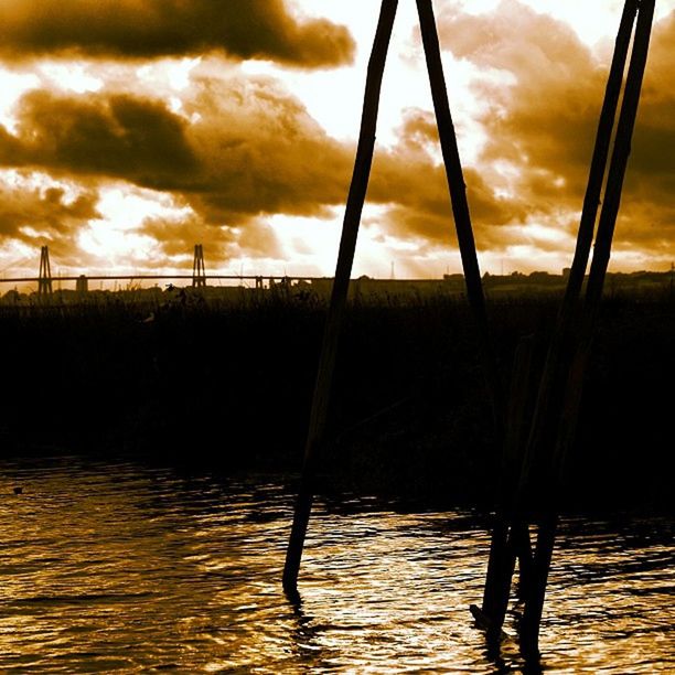 sunset, water, sky, silhouette, sea, cloud - sky, orange color, reflection, scenics, waterfront, beauty in nature, tranquility, nature, horizon over water, cloudy, idyllic, rippled, cloud, tranquil scene, dramatic sky