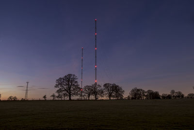 Low angle view of  antenna on field against sky