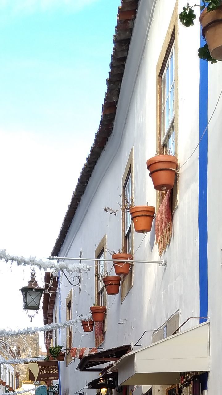 LOW ANGLE VIEW OF RESIDENTIAL BUILDING AGAINST SKY