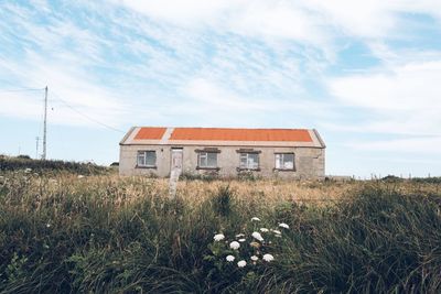 House on field against sky