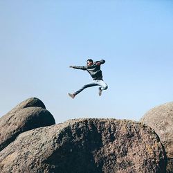 Low angle view of jumping jumping against clear sky