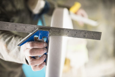 Surfboard shaper measuring a new design