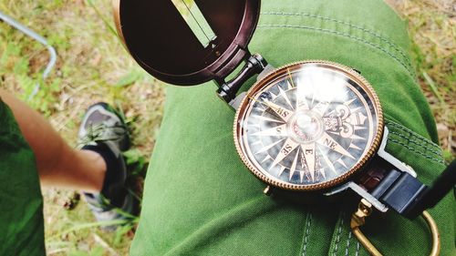 Low section of person with clock on metal