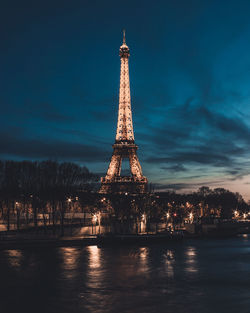 Tower in city against sky at night