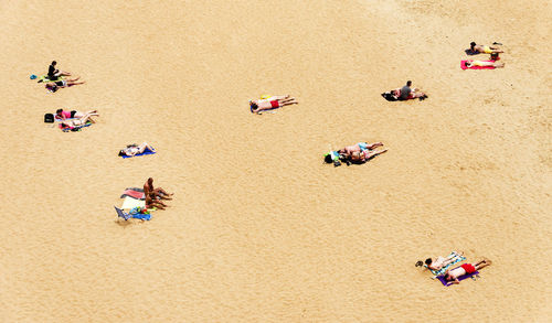 View of people sunbathing on shore