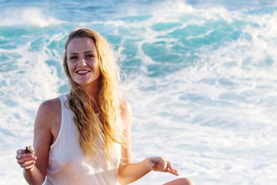 Portrait of beautiful woman with long hair at beach