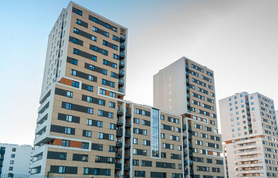 Low angle view of buildings against sky in city