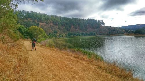 Scenic view of lake against cloudy sky