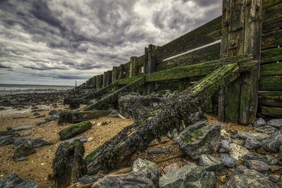 View of rocks on beach against sky