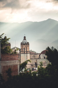 Historic building by mountains against sky