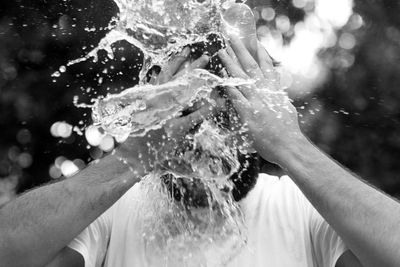 Close-up of man washing face with water