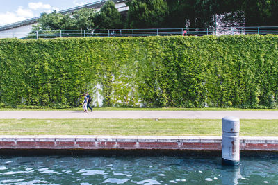 People walking by spree river in park