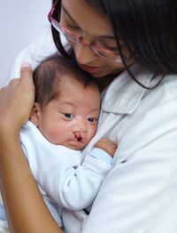 Nurse holding baby in clinic