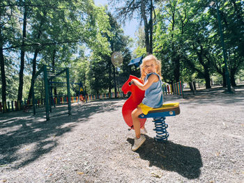 Full length of boy playing on slide at park