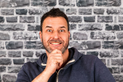 Portrait of a smiling young man against wall