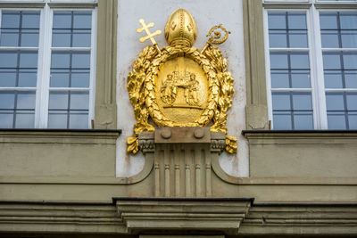 Golden coat of arms carving on roman catholic archdiocese of cologne