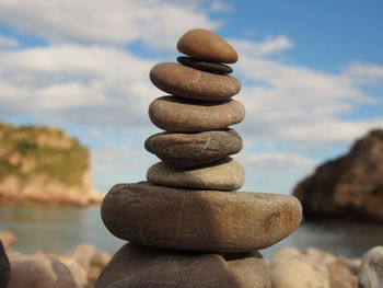 Close-up of stack of stones by the sea