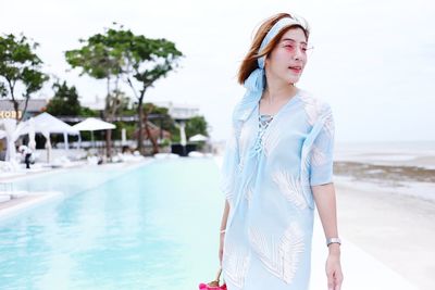 Young woman standing in swimming pool