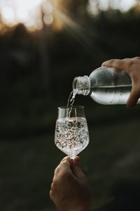 Person pouring water into glass