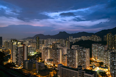 High angle view of illuminated buildings against sky at night