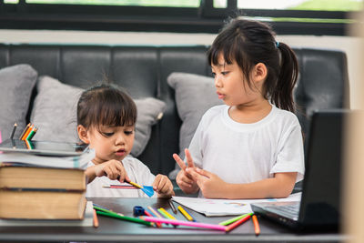 Cute girl and son on table