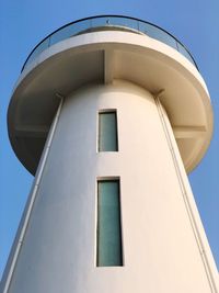 Low angle view of water tower against clear blue sky