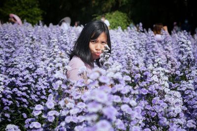 Portrait of girl on purple flowering plants