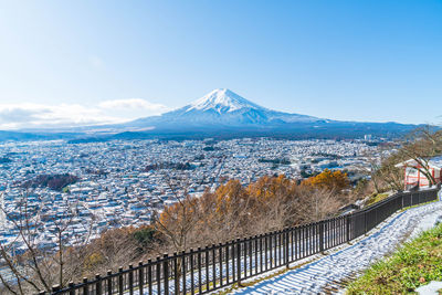 Scenic view of snowcapped mountain in city