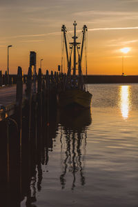 Silhouette pier on sea against sky during sunset